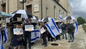 Participants at a May 22, 2025, afternoon vigil to honor the two lives lost in an attack outside the Capital Jewish Museum in Washington, D.C., the night before hold signs reading “Christians and Jews united against hate.”