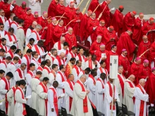 Cardinals, bishops, and priests carrying palm branches gather for the Palm Sunday Mass in St. Peter’s Square, April 13, 2025.