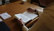 Dominican Father Thomas Joseph White reads the thesis of then-Father Robert Prevost, now Pope Leo XIV, titled “The Role of the Local Prior in the Order of St. Augustine,” which Prevost wrote while a student at Rome’s Pontifical University of St. Thomas Aquinas in the early 1980s.
