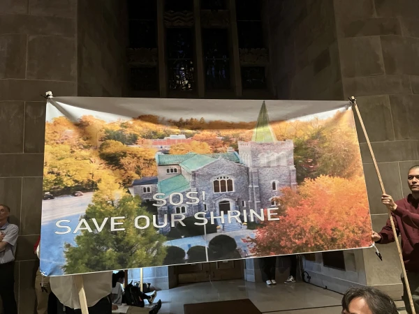 Parishioners from the Shrine of the Sacred Heart in Baltimore's Mount Washington neighborhood display an “SOS! Save Our Shrine” banner at an April 30, 2024, listening session. Credit: Matthew Balan